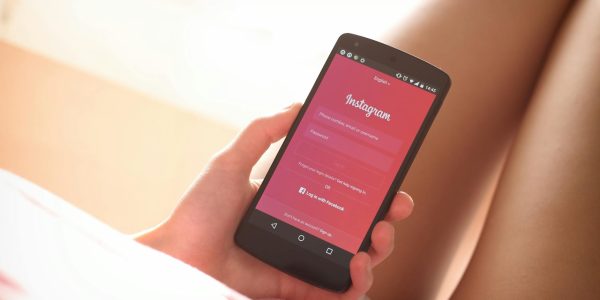 woman holding black smartphone